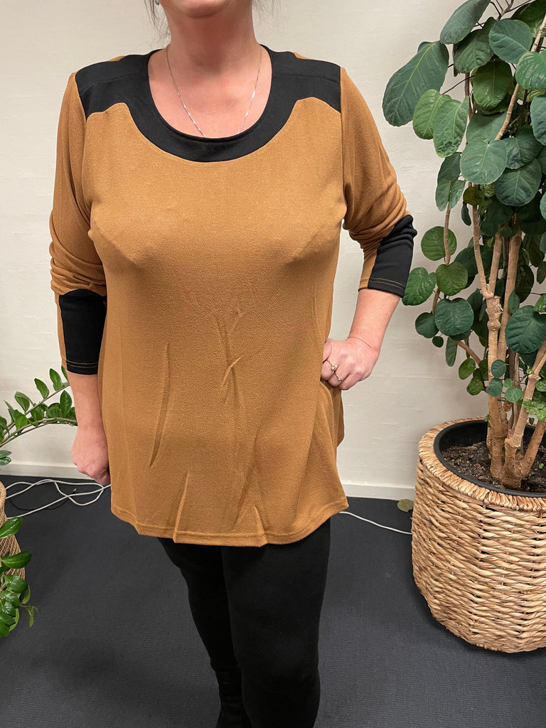 Pronto Woman | Lis G bluse Camel-45 bæres af kvinde foran plante.