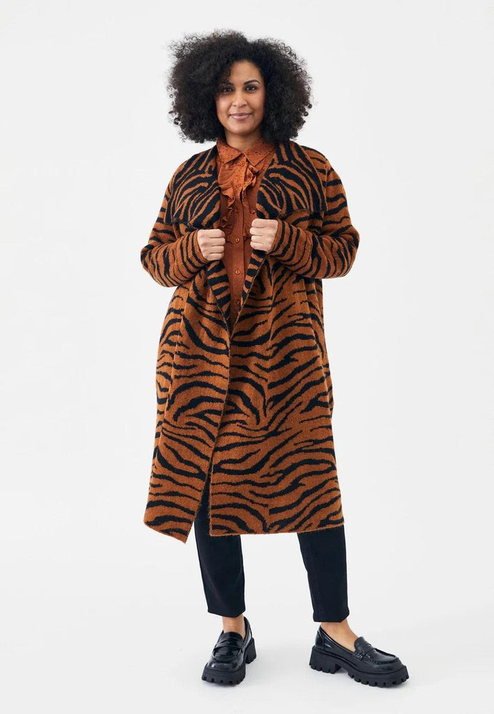 Kvinde i Adia Tiger Strik cardigan med tigerstribet design.